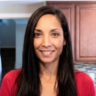 Stephanie smiling with long dark hair.